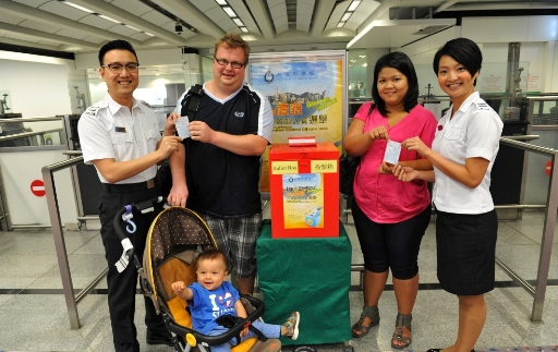 Smiling Immigration Control Officers invite visitors to vote for the most courteous Immigration Control Officers