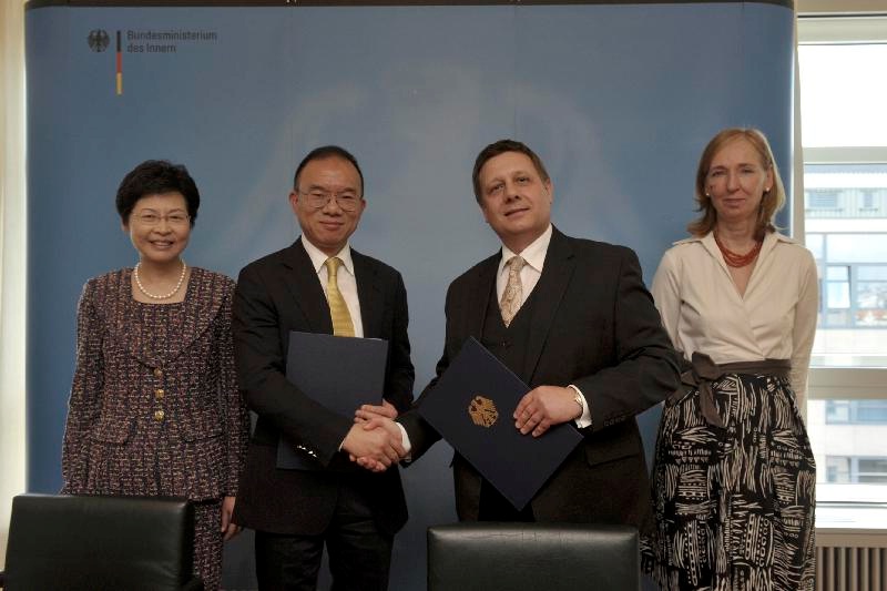 Mr Tsang (second left) and Mr Andreas Reisen (second right) exchange the signed copies of the Memorandum of Understanding. Mrs Lam (first left), and Dr Emily Haber (first right), witness the signing.