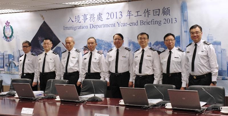 The Director of Immigration, Mr Chan Kwok-ki (fourth right), chairs the Immigration Department year-end review for 2013 today (January 27).