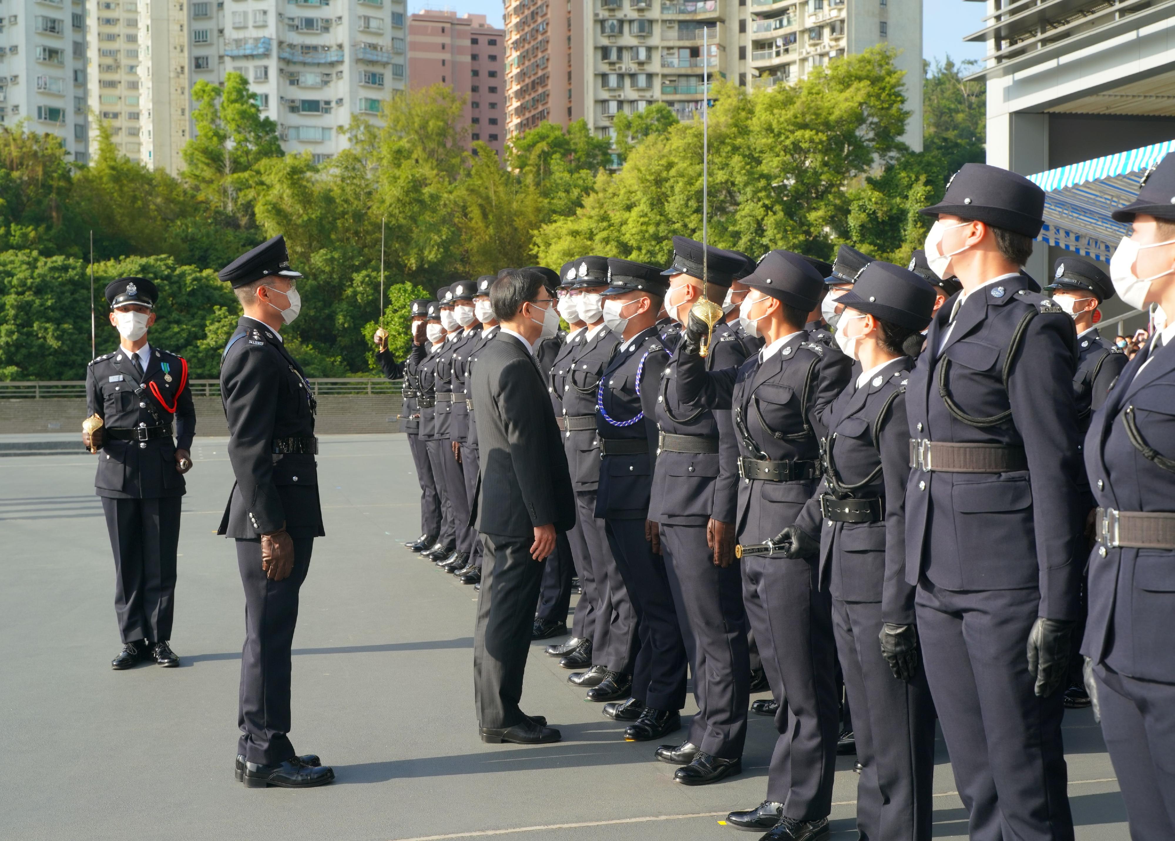 The Chief Executive, Mr John Lee, inspects a contingent of graduates at the Immigration Department Passing-out Parade today (December 2).