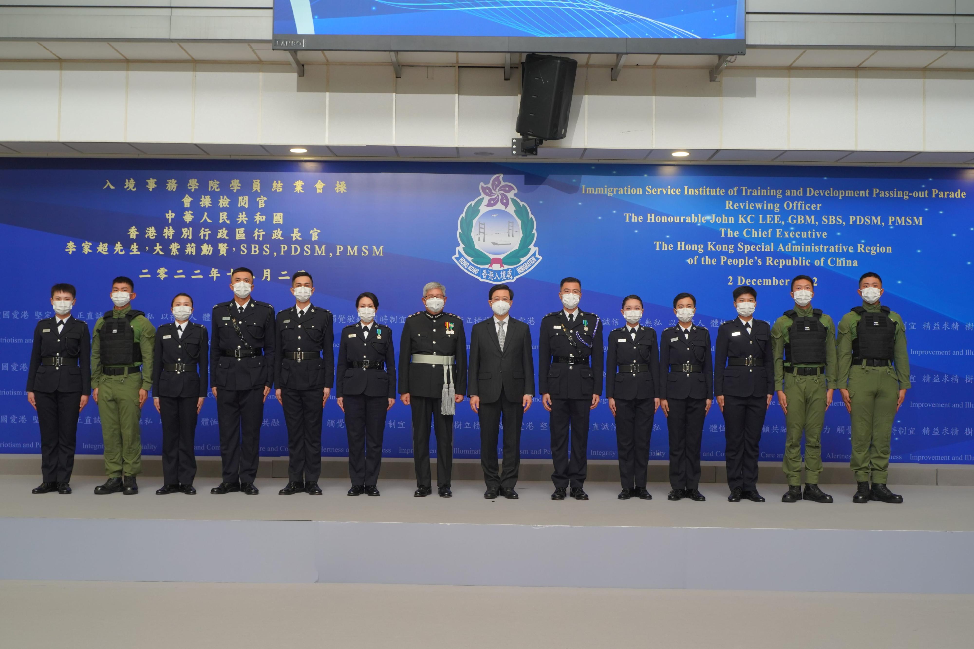 The Chief Executive, Mr John Lee (seventh right), is pictured with the Director of Immigration, Mr Au Ka-wang (seventh left), as well as graduates awarded the “Best Recruit Shields” and other guests, after the Immigration Department Passing-out Parade today (December 2).