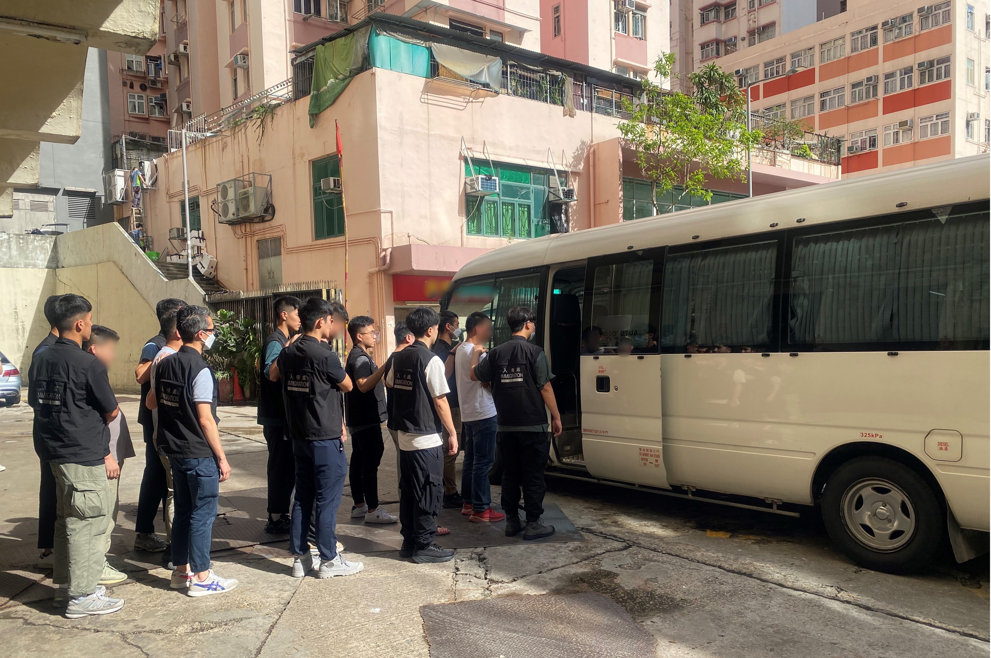 Photo shows suspected illegal workers arrested during an operation.