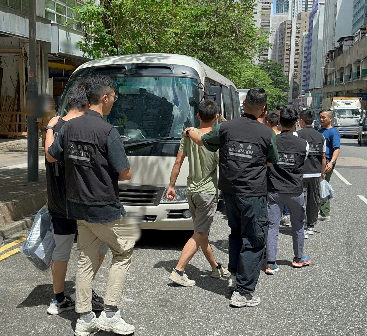 Photo shows suspected illegal workers arrested during an operation.