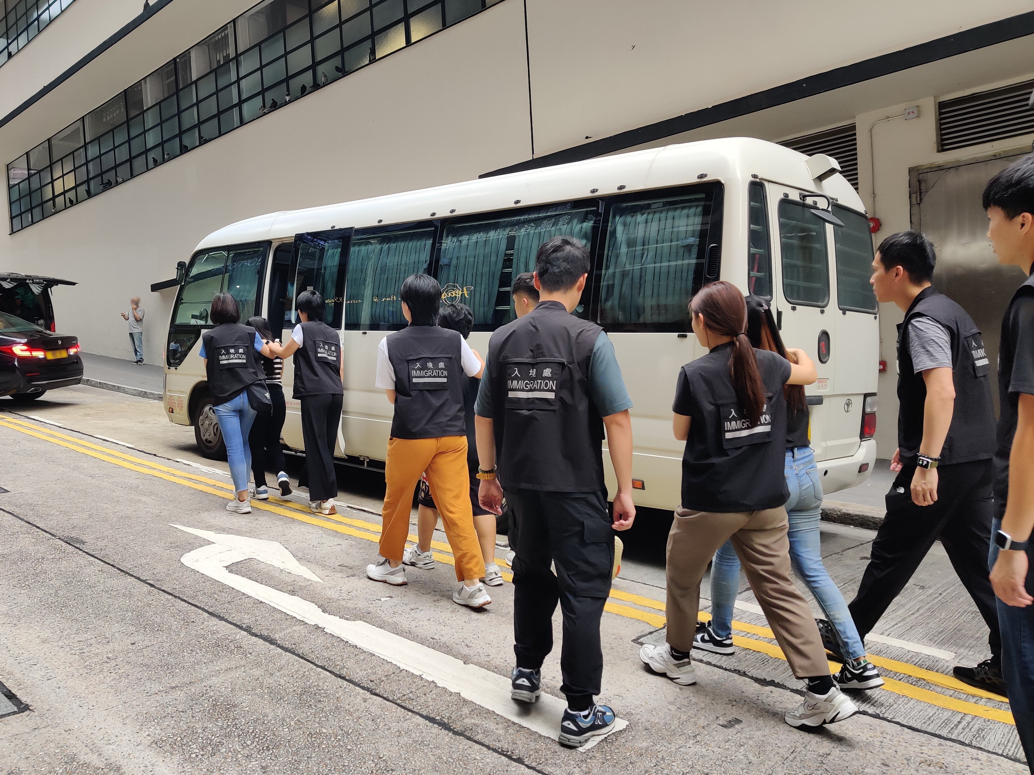 Photo shows suspected illegal workers arrested during an operation.