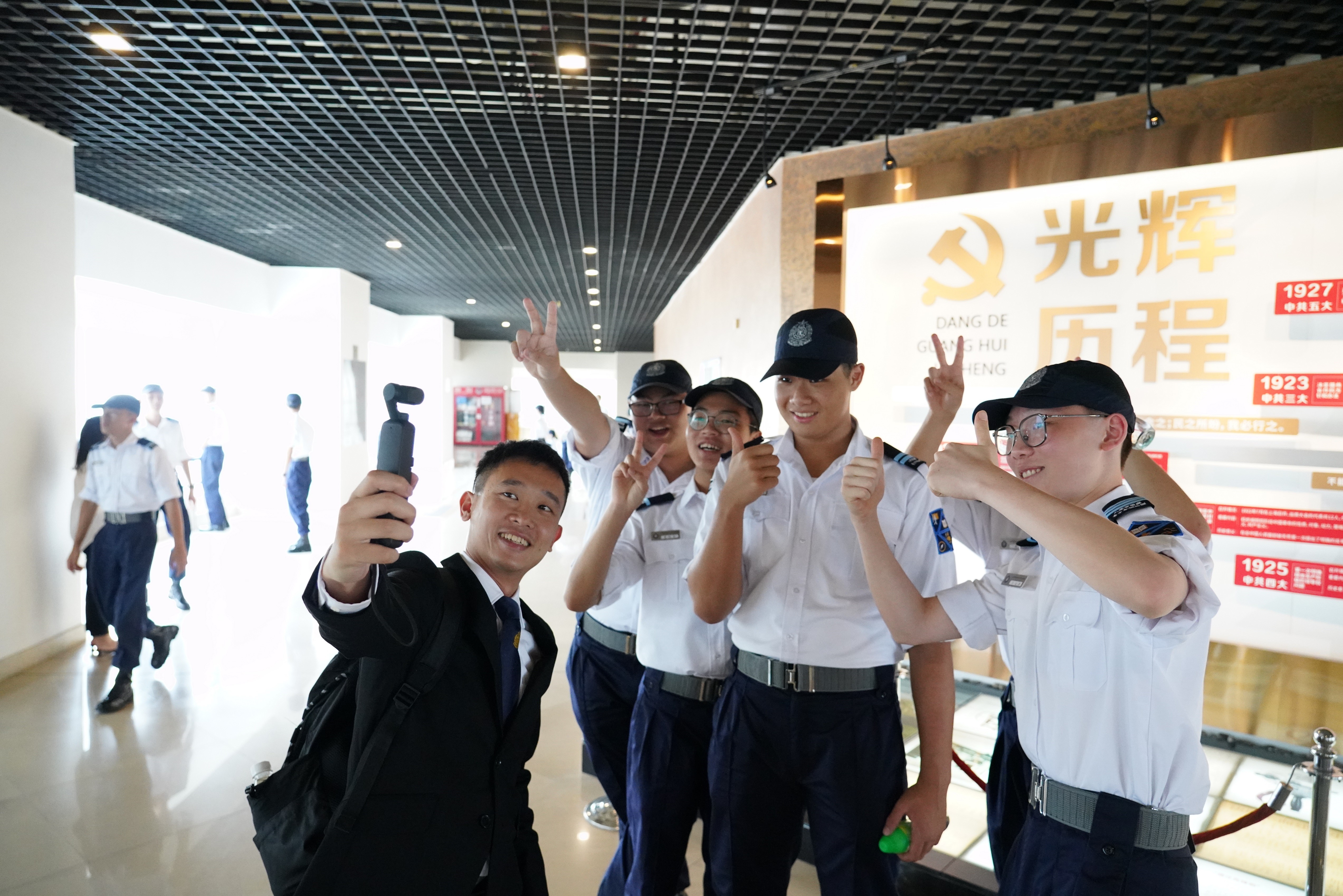 The Immigration Department Youth Leaders Corps members are pictured with a training officer of the Immigration Service Institute of Training and Development in Guangzhou on July 24.