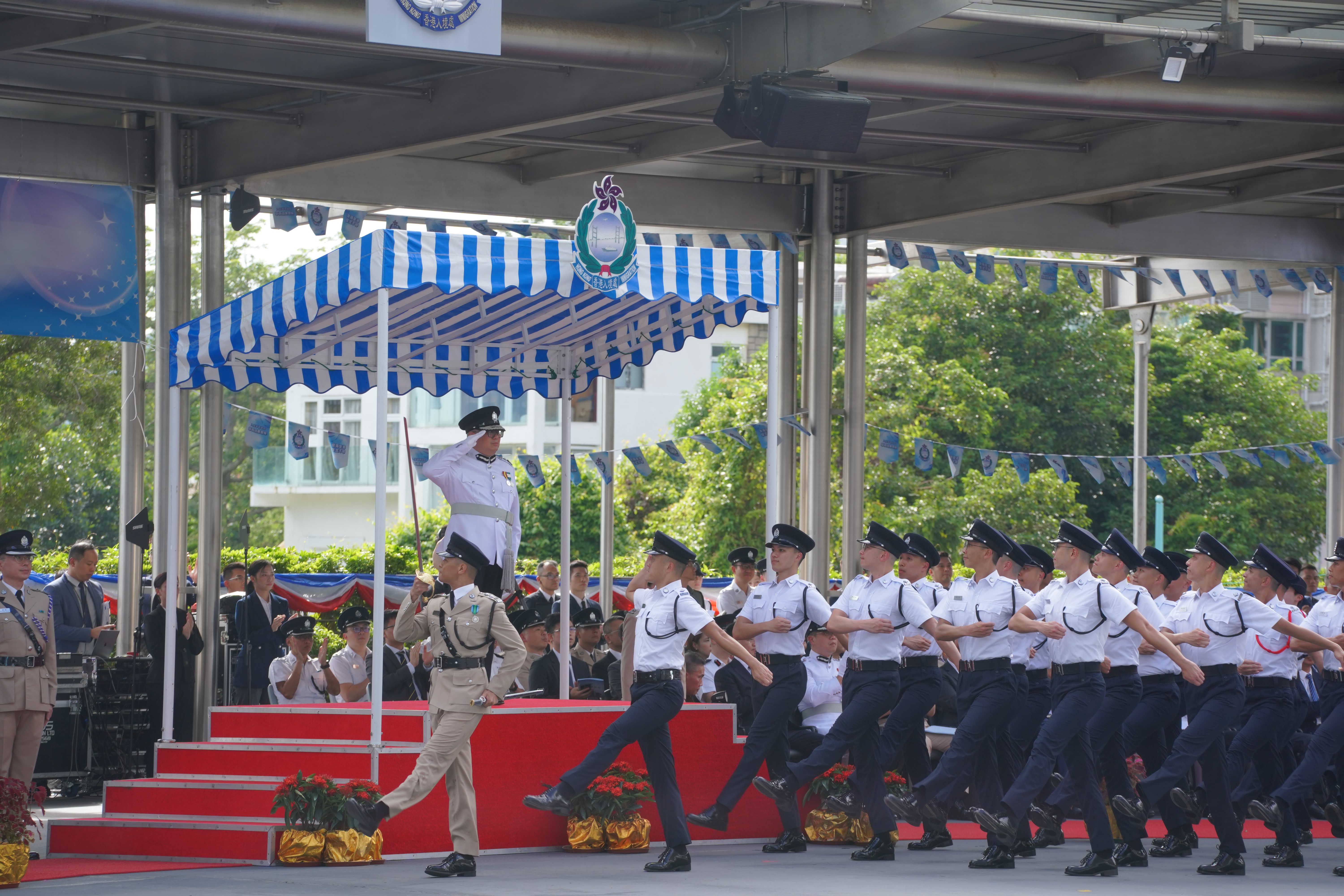 Photo shows passing-out officers goose-stepping past the dais in the Chinese-style footdrill performance.