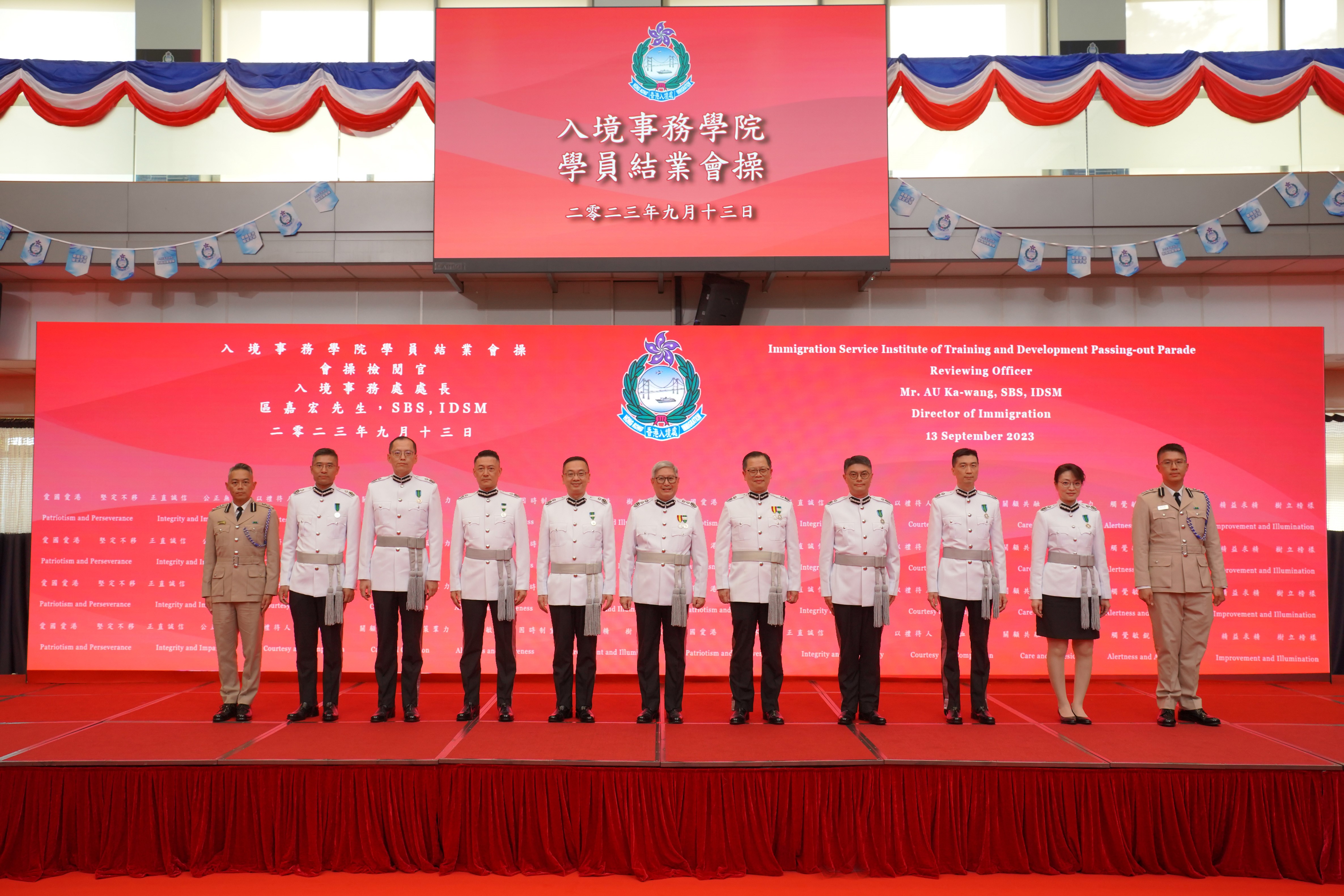 Photo shows the Director of Immigration, Mr Au Ka-wang (sixth right), taking a photo with directorate officers of the Immigration Department after the parade.