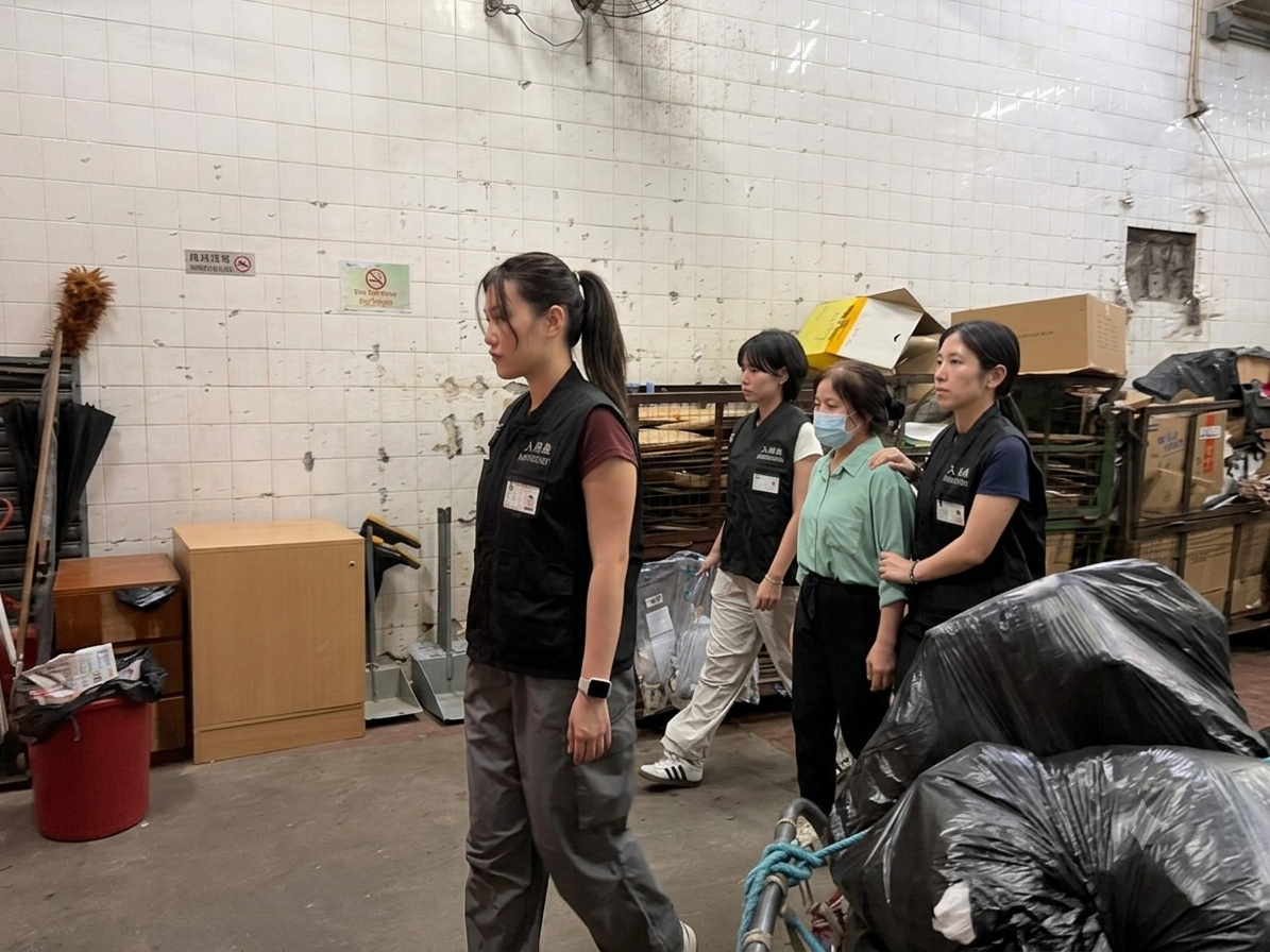 Photo shows a suspected illegal worker (second right) arrested during an operation