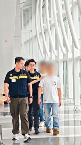 Photo shows removees being escorted by ImmD officers to depart from Hong Kong